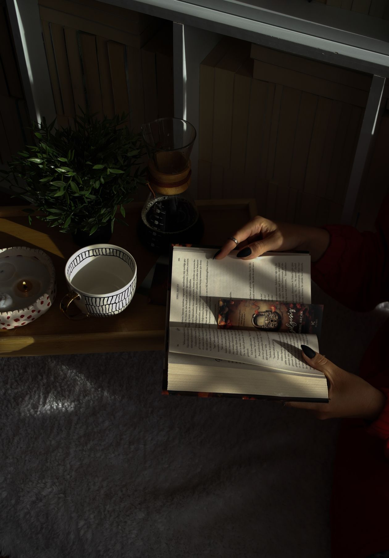 Cozy reading nook with a warm cup of tea and a mystery novel