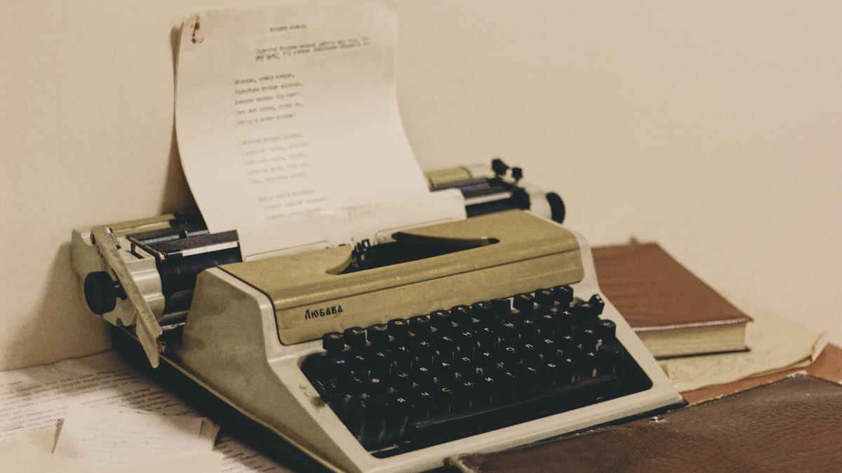 Vintage typewriter and books on a writer's desk