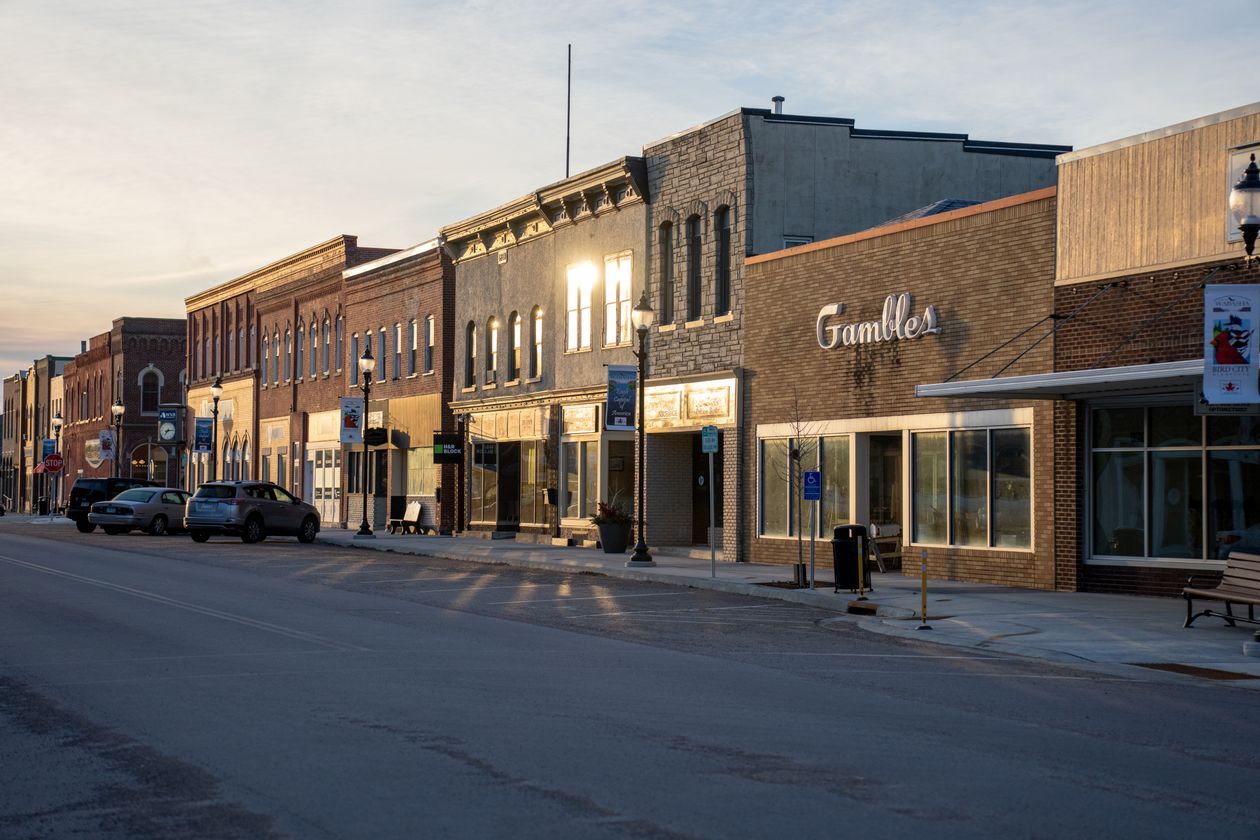 Golden hour light on a small town main street with brick storefronts